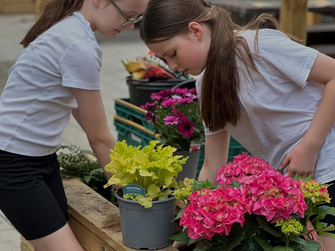 Huntingdon memorial garden planting flowers in beds